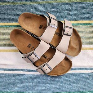 Birkenstock Arizona two-strap sandals in creamy white and tan 9-9.5